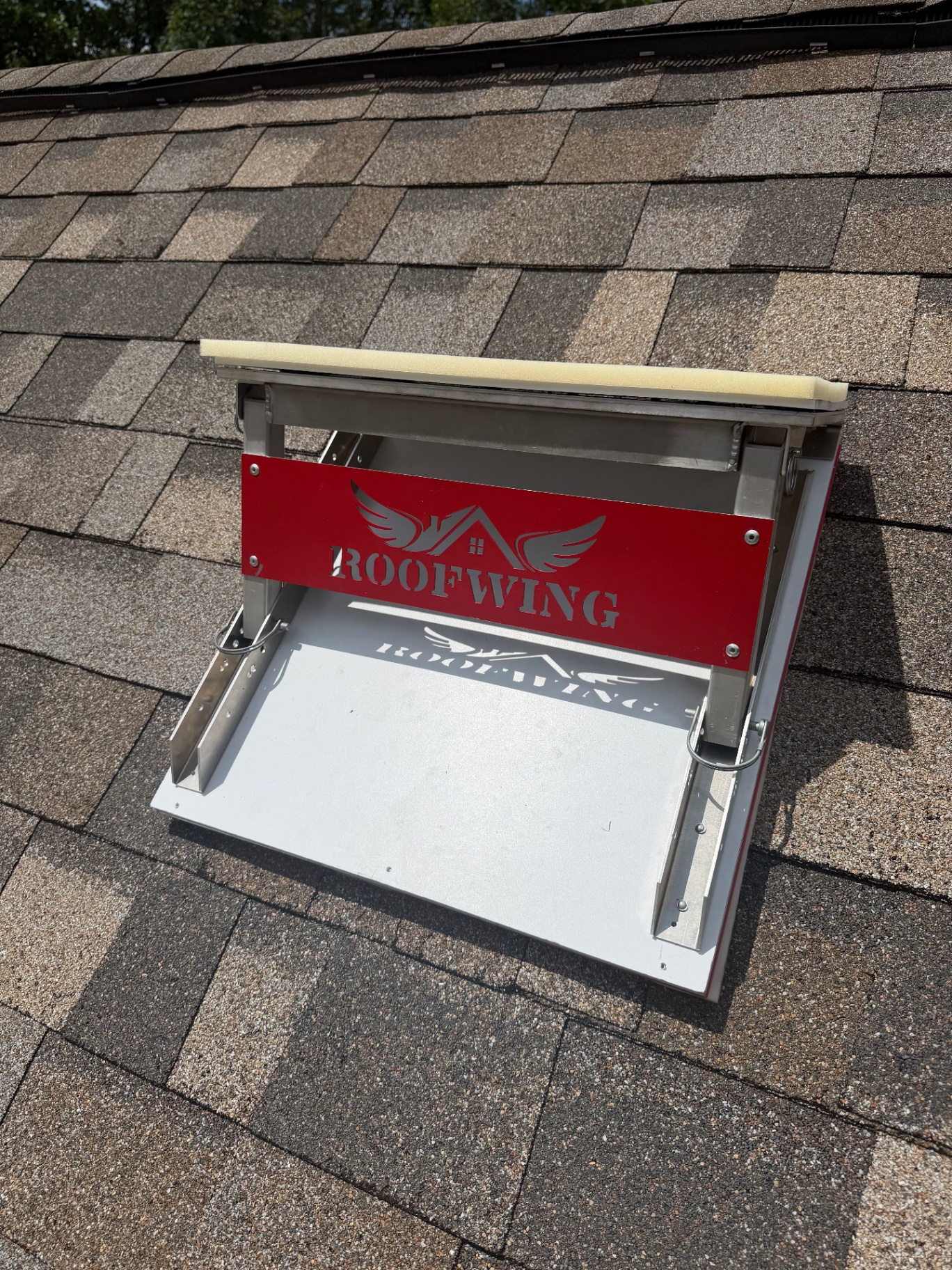The Roofwing installed and seated against shingles on a real roof